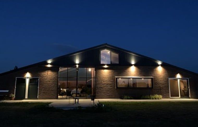 Vacation home in Zalk lit in the evening, a charming residence in Northwest Overijssel, Overijssel.