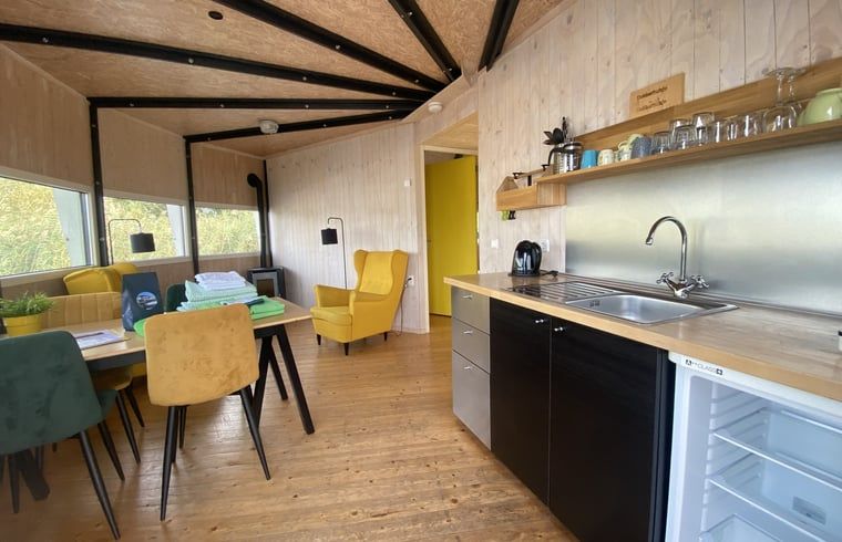 Cozy indoor area of Cottage in IJsselstein, Utrecht. Vacation home with modern kitchen and cozy sitting area for a relaxing stay.