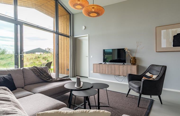 Modern living room in Holiday home in Wissenkerke, Noord-Beveland, Zeeland with large window.