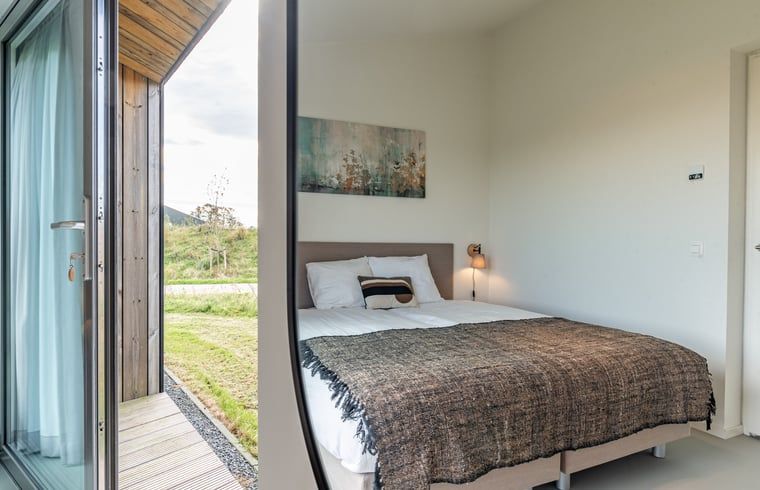 Bedroom with view in Holiday home in Wissenkerke, Noord-Beveland, Zeeland.