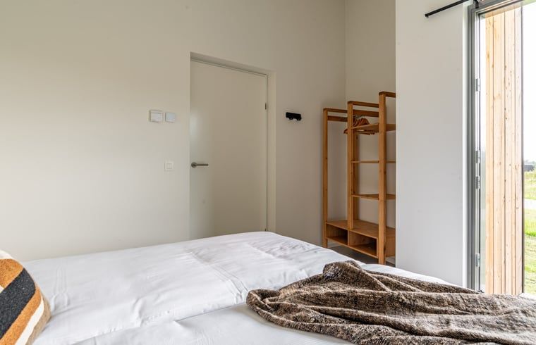Bedroom with wooden closet in Holiday home in Wissenkerke, Noord-Beveland, Zeeland.