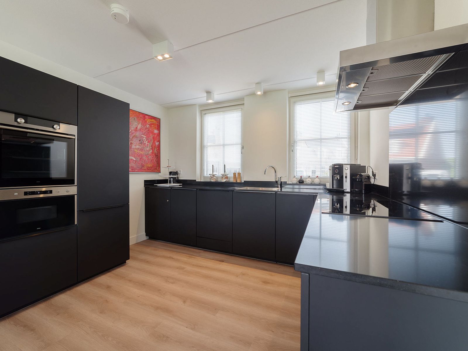 Stylish black kitchen in Holiday Home Ganuenta, Colijnsplaat, North Beveland with modern appliances.