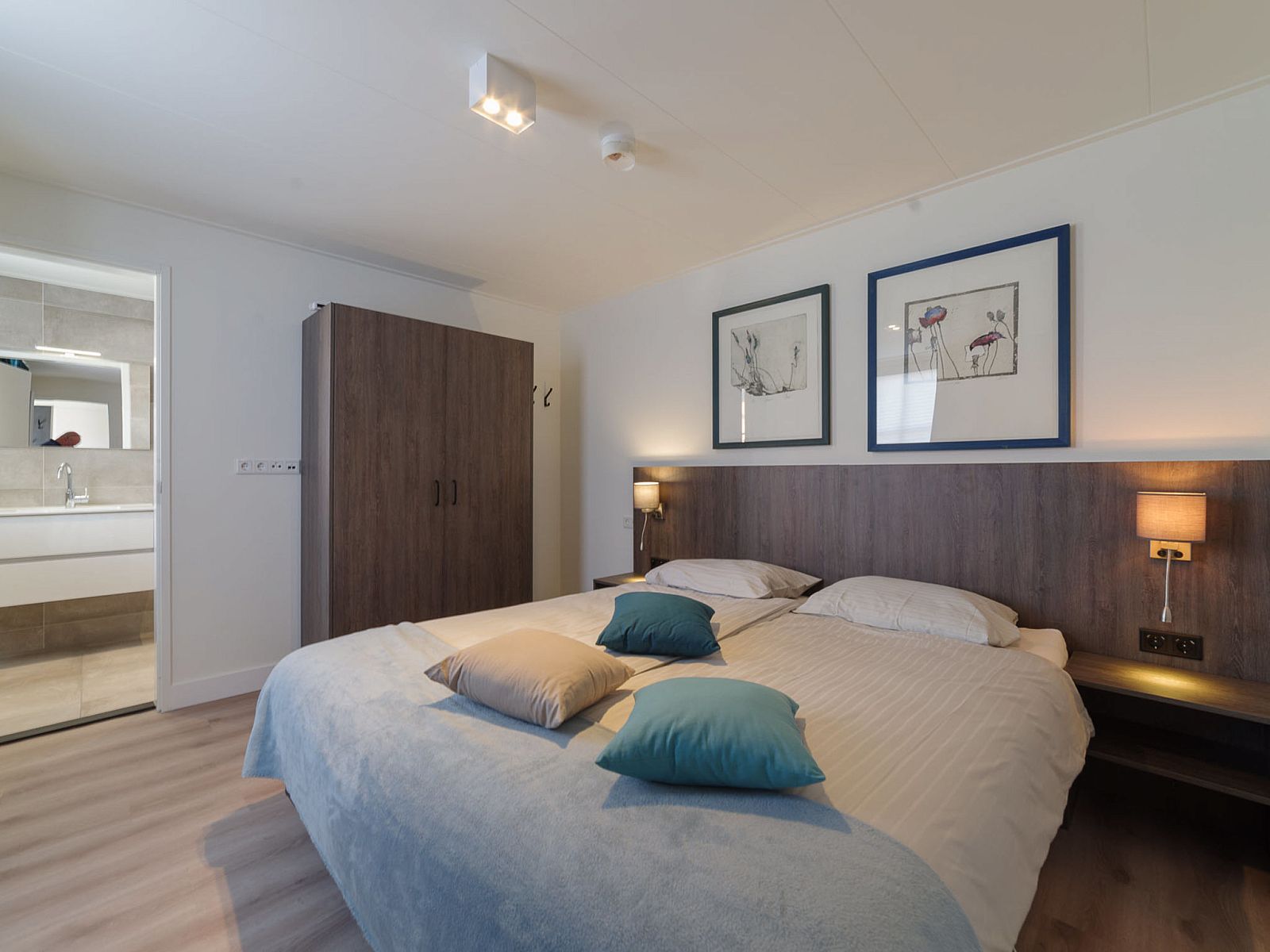 Comfortable bedroom in Holiday Home Ganuenta, Colijnsplaat, Noord-Beveland with ensuite bathroom.