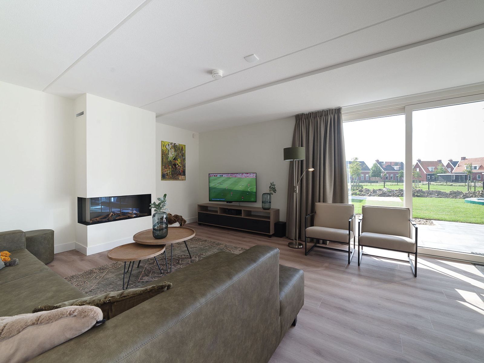 Spacious living room in Holiday Home Ganuenta, Colijnsplaat, North Beveland with modern furnishings and garden views.