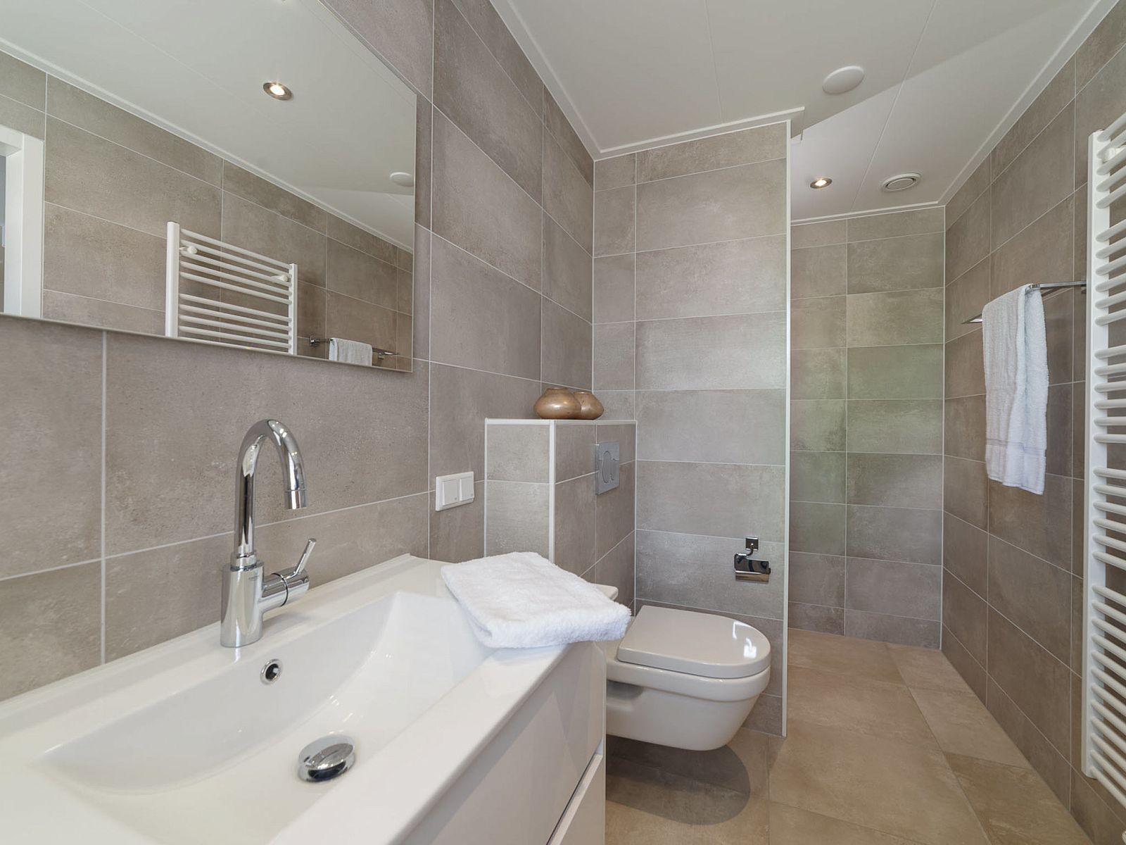 Luxury bathroom in Holiday Home Ganuenta, Colijnsplaat, Noord-Beveland with modern sink and shower.