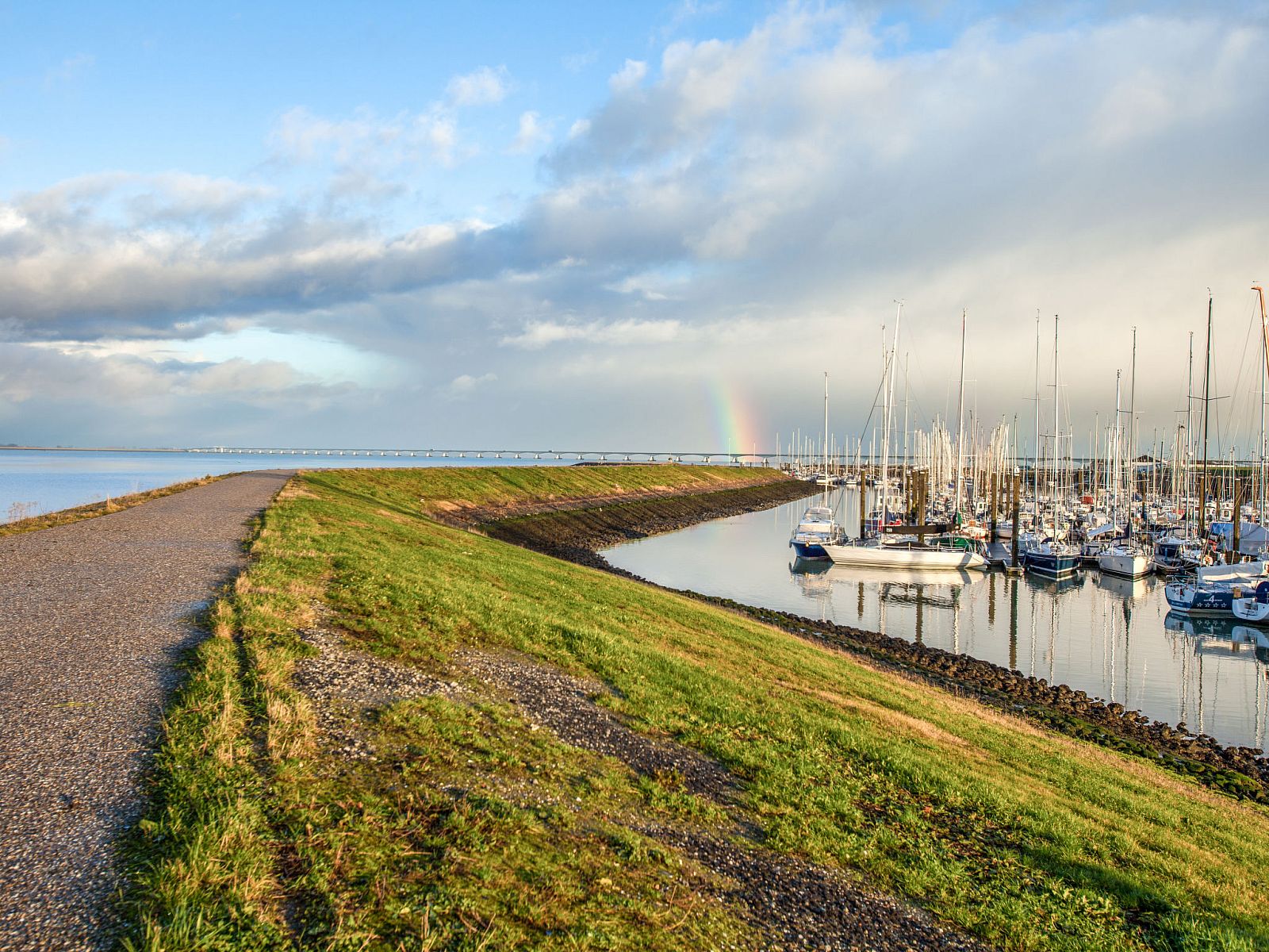 View of the marina near Holiday Home Ganuenta, Colijnsplaat, North Beveland with rainbow and boats.