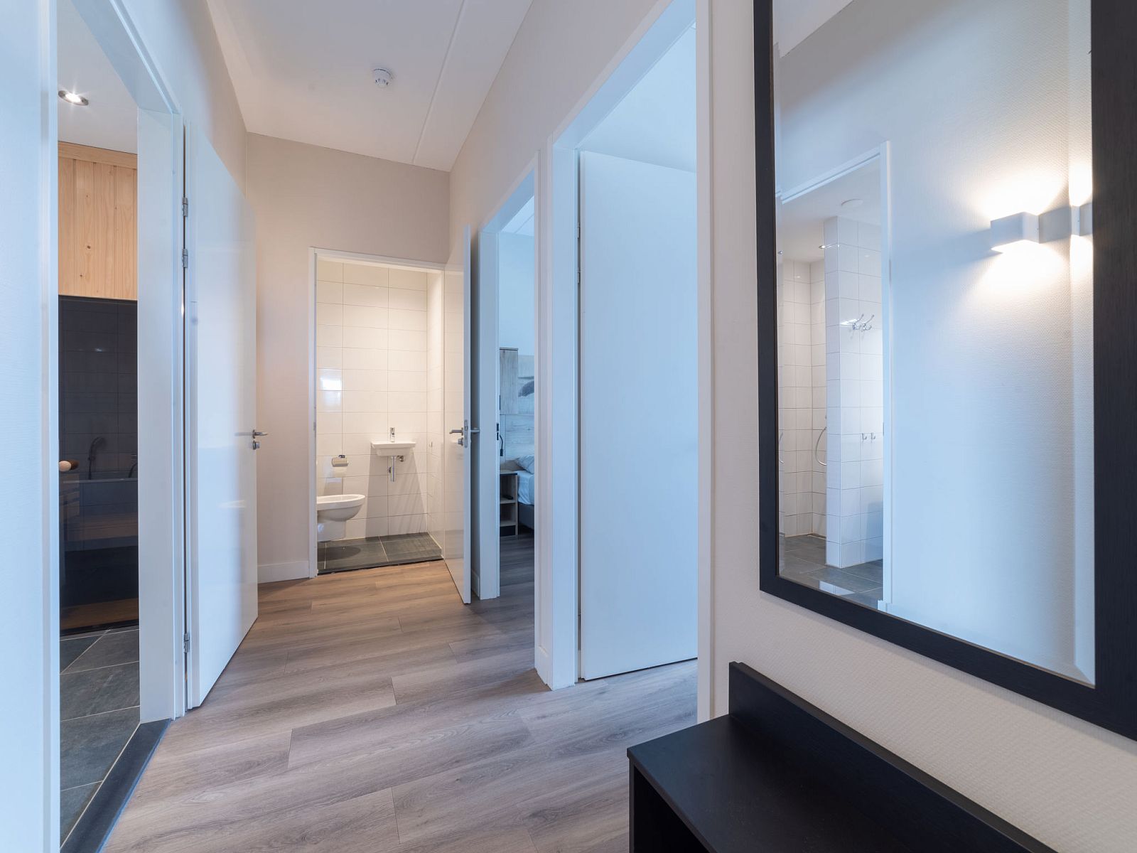 Korridor im Apartment Ganuenta, Colijnsplaat, Noord-Beveland, mit Zugang zu mehreren Zimmern und modernem Boden.