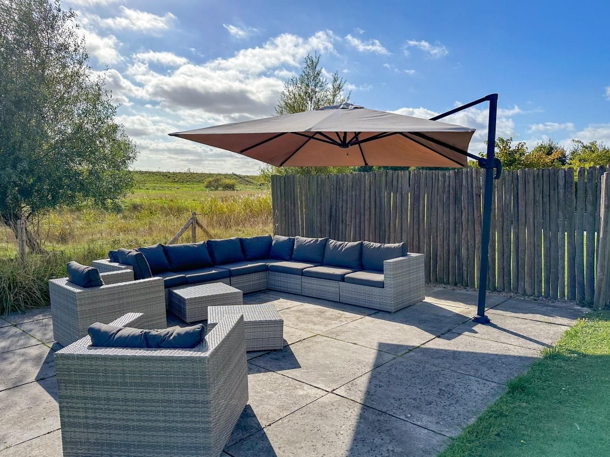 Ontspannen terras bij Dune Design 39 vakantiehuis in Colijnsplaat, Noord-Beveland, met uitzicht op de serene natuur van Zeeland.