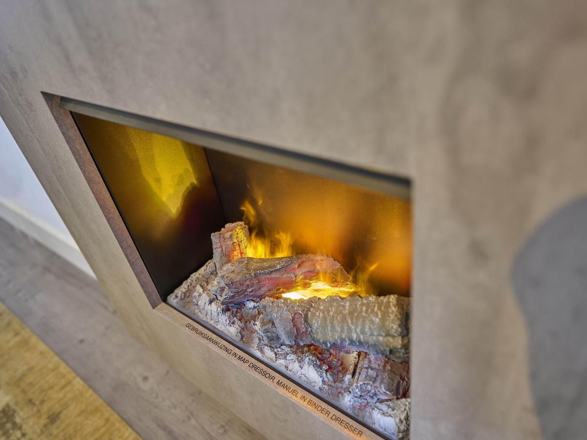 Cozy fireplace in Sauna Zee 27H, a vacation home in Colijnsplaat, North Beveland, Zeeland, offers cozy warmth and atmosphere.