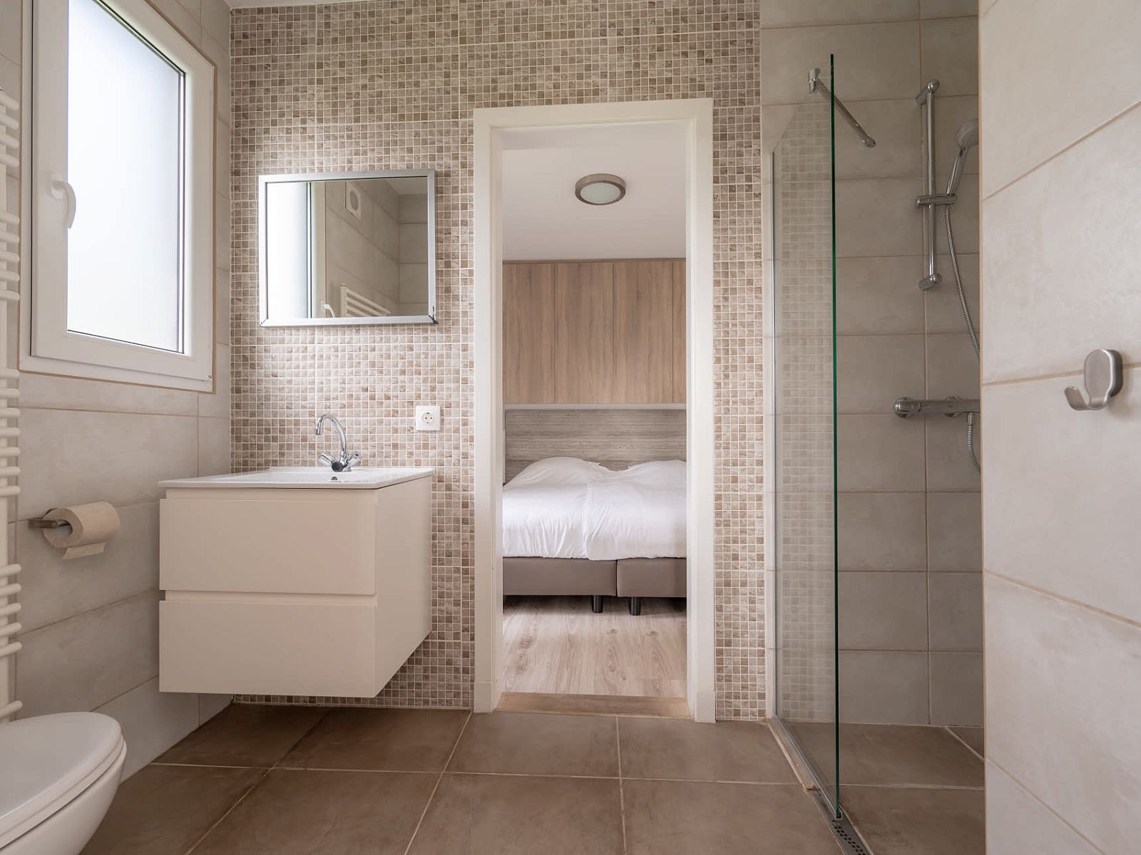 Moderne badkamer in Bungalow de Boei, Kamperland, met toegang tot de slaapkamer in Noord-Beveland, Zeeland.