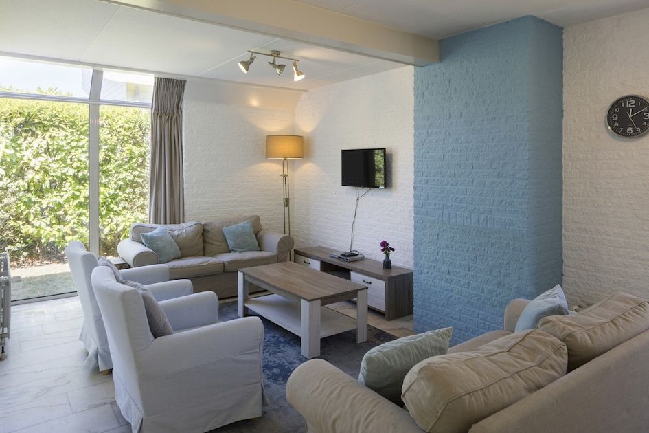 Bright interior of bungalow RJV in Kamperland, North Beveland, Zeeland with large windows and modern interior.