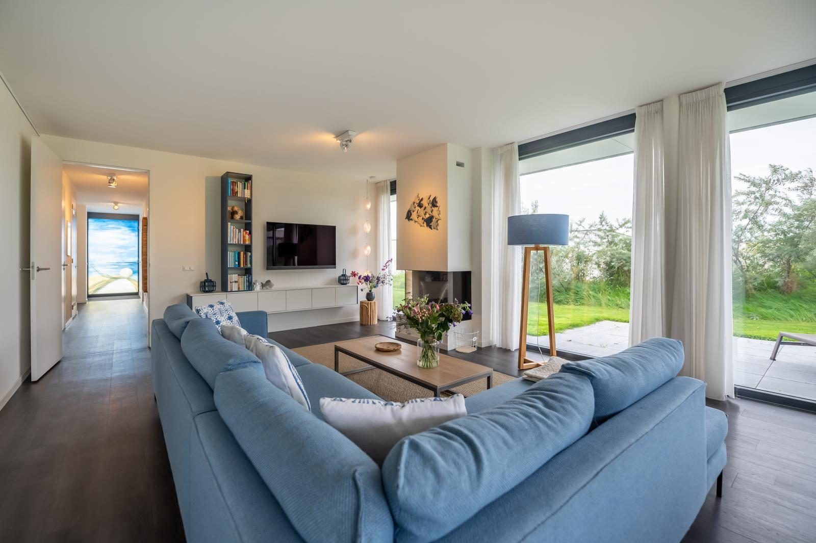 Stilvolles Wohnzimmer in Duinvallei 09, Ferienhaus in Kamperland, Noord-Beveland, mit moderner Einrichtung und Gartenblick.