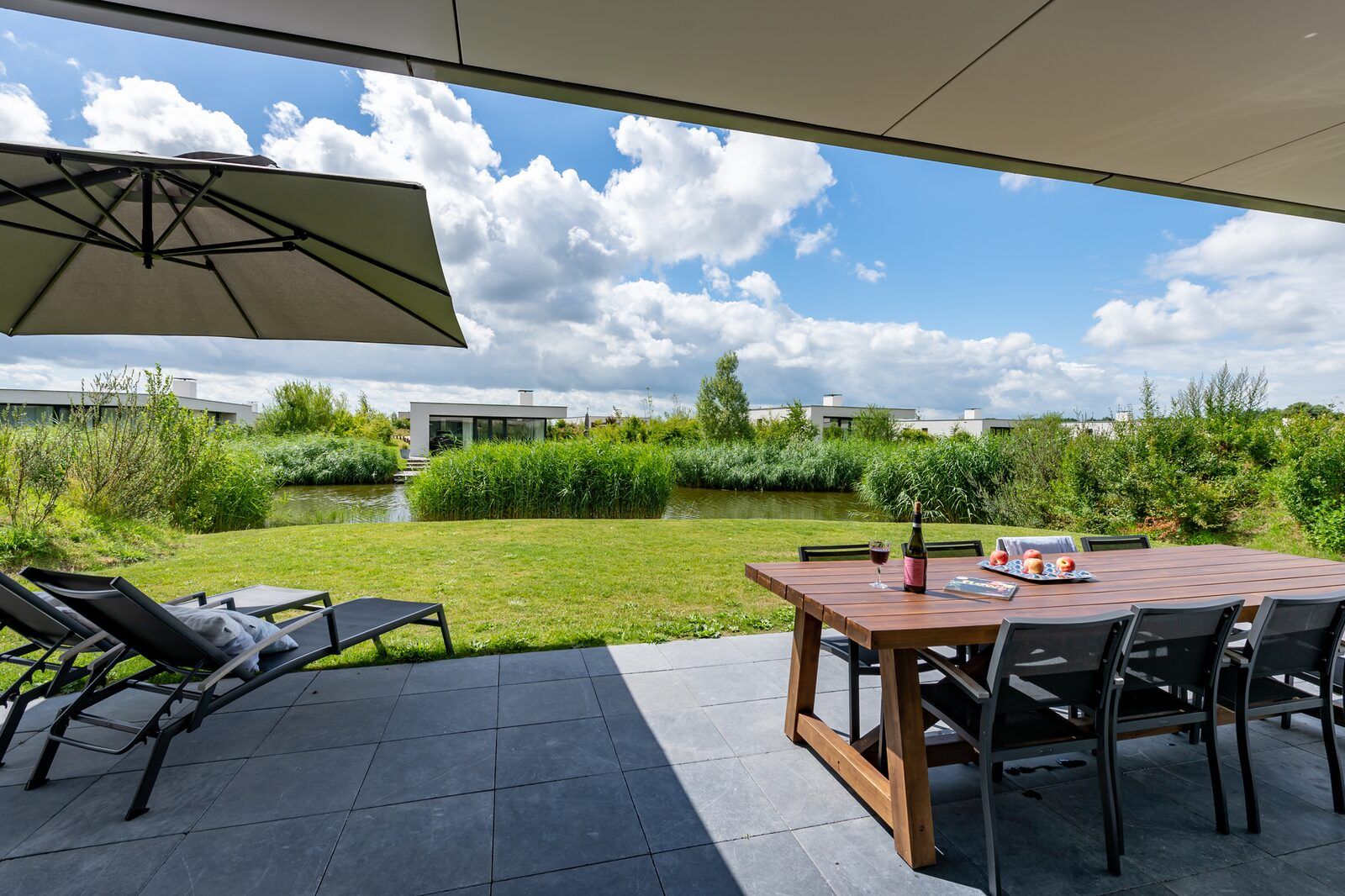 Relax on the veranda of Duinvallei 10 | De Groote Duynen in Kamperland, a luxury vacation home surrounded by the tranquility of Zeeland.