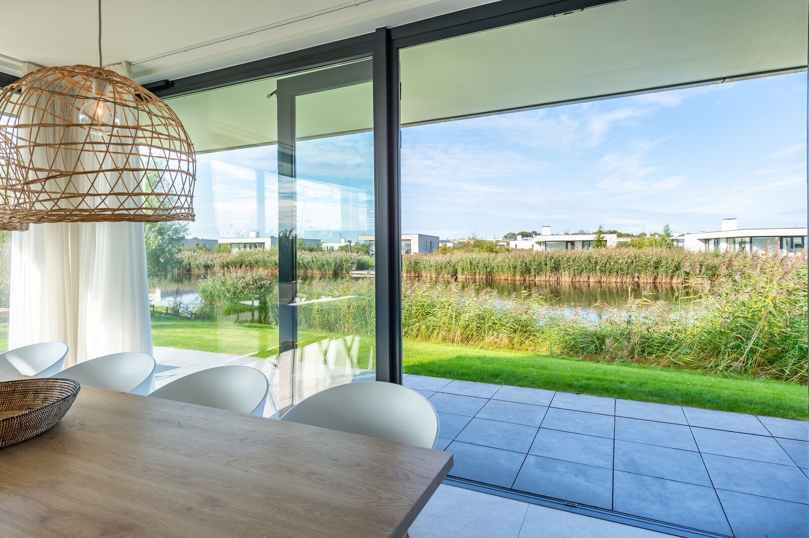 Dining room overlooking nature at Waterline 09, vacation home in Kamperland, Zeeland.