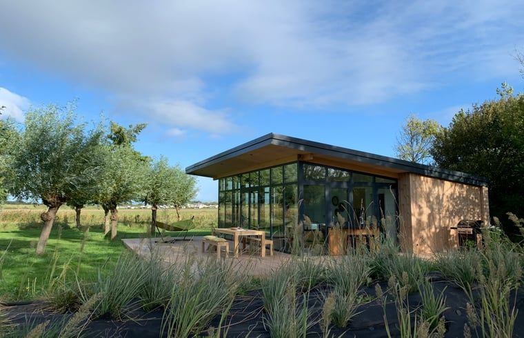 Modern vacation home in Kamperland with spacious veranda surrounded by nature, perfect for relaxation in North Beveland, Zeeland.