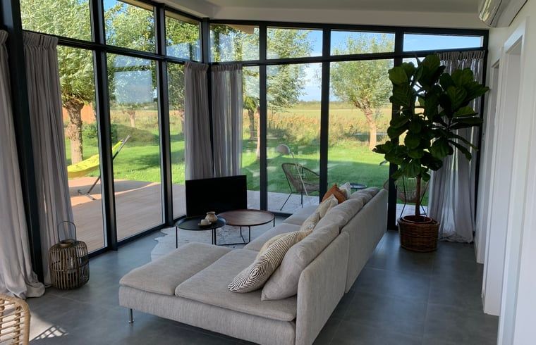 Bright living room in vacation home in Kamperland overlooking the garden in North Beveland, Zeeland.