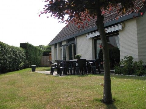 Sunny terrace of Mi Casa, Burgh-Haamstede, Zeeland, with seating for outdoor meals and relaxation.
