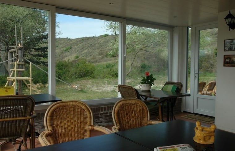 Veranda mit Blick auf die Duenen im Haus in Burgh-Haamstede, ideal fuer Entspannung in Zeeland.