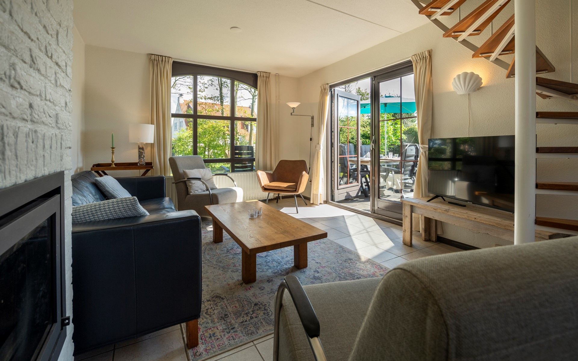 Spacious living room of Holiday home Schouwse Duin 35 in Burgh-Haamstede with access to the terrace in Zeeland.