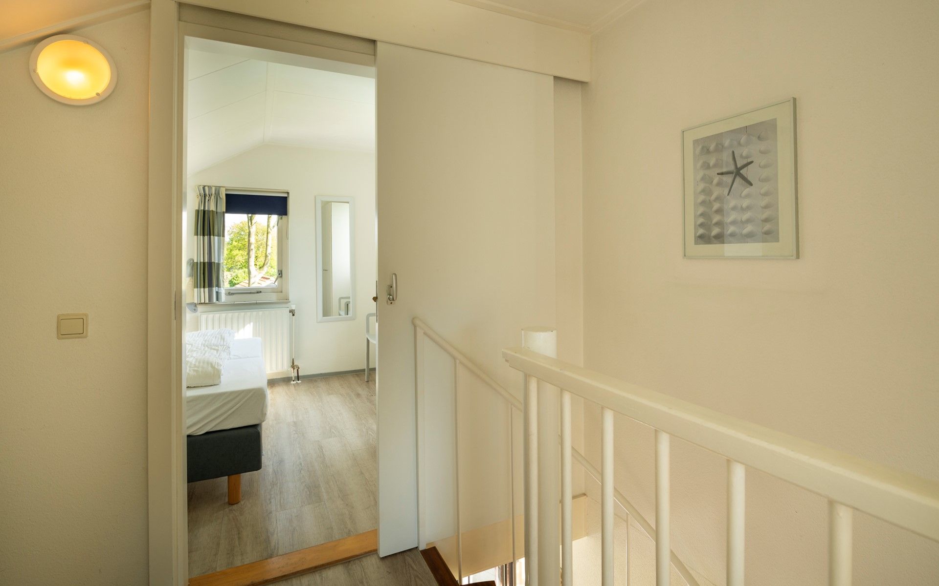 Bright bedroom in Holiday home Schouwse Duin 35, Burgh-Haamstede, with two single beds and garden view in Zeeland.