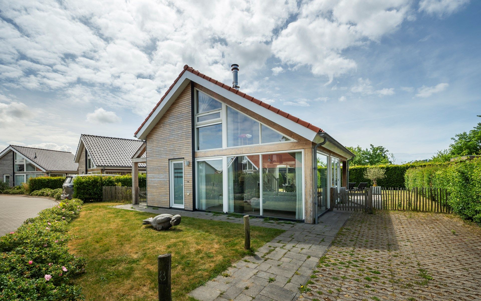 Seitenansicht des Ferienhauses Zonnedorp 8, De Zeehond in Renesse, Zeeland mit einem gepflegten Garten.