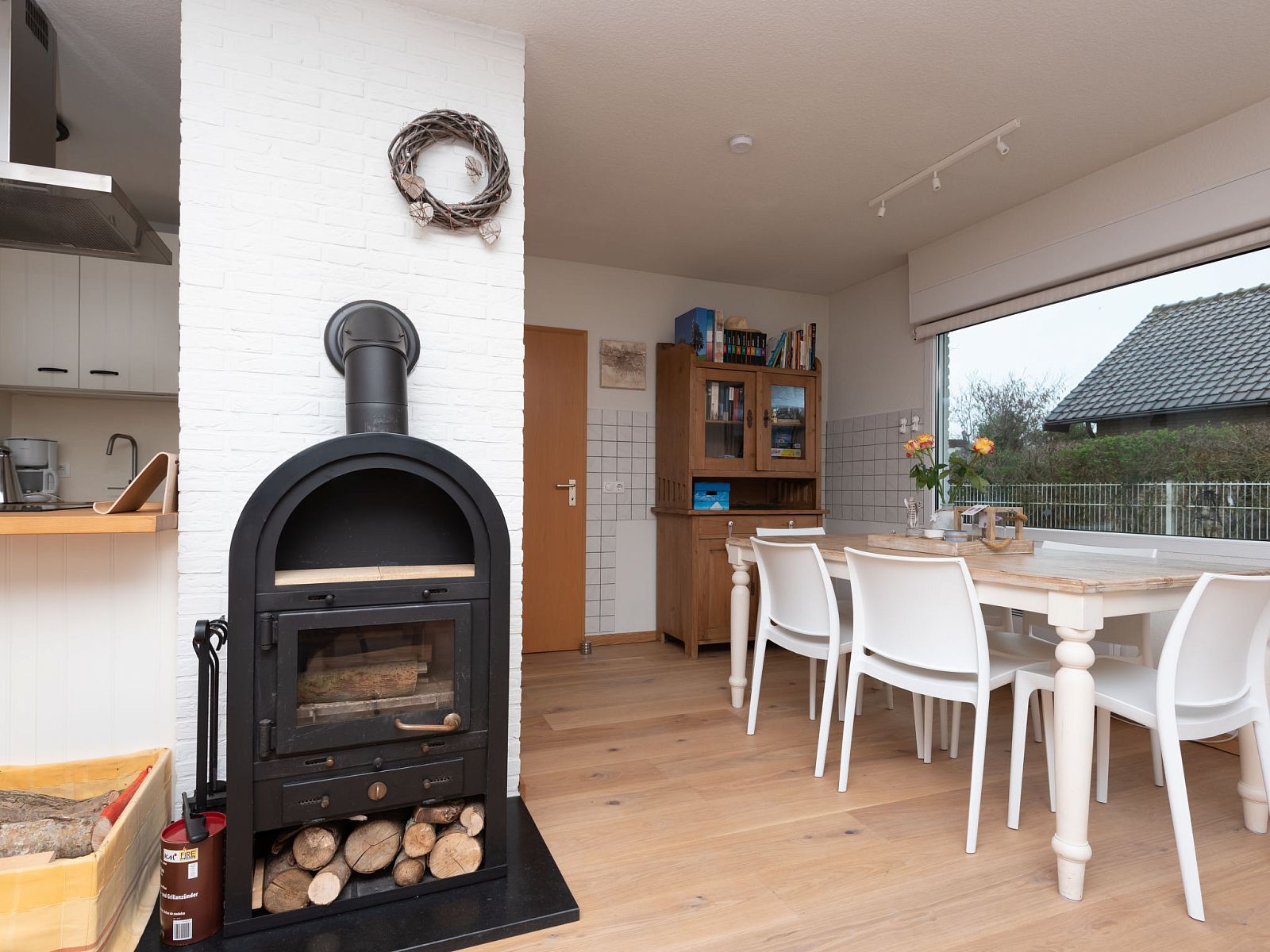 Dining room with wood stove in Holiday home Horizon by the Sea, Renesse, offers a warm and cozy atmosphere.