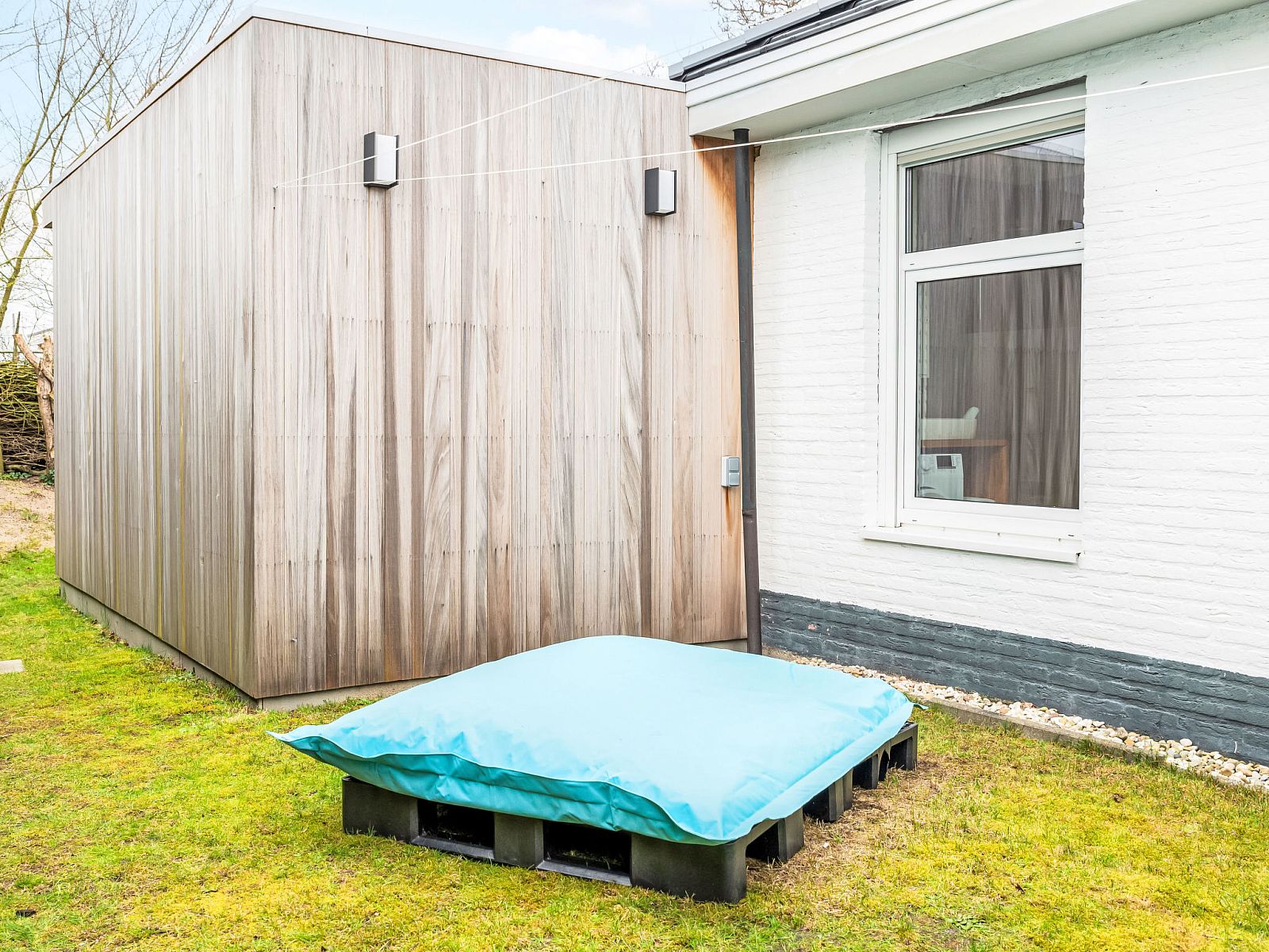 Backyard with wooden shed at Holiday Home Horizon by the Sea, Renesse, offers extra space.