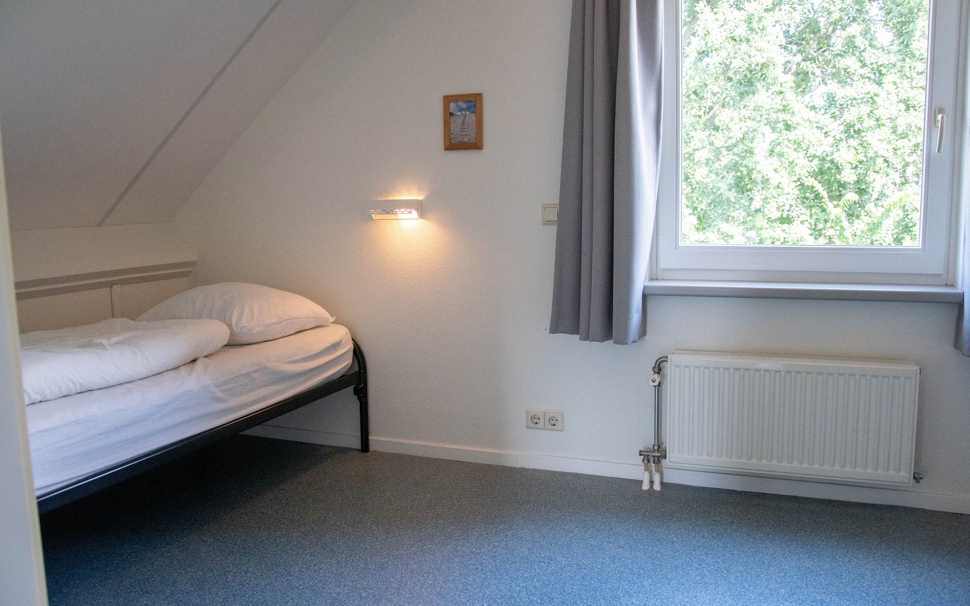 Spacious hallway with wooden stairs in Holiday home Horizon 95, ideal for access to the upper floor.