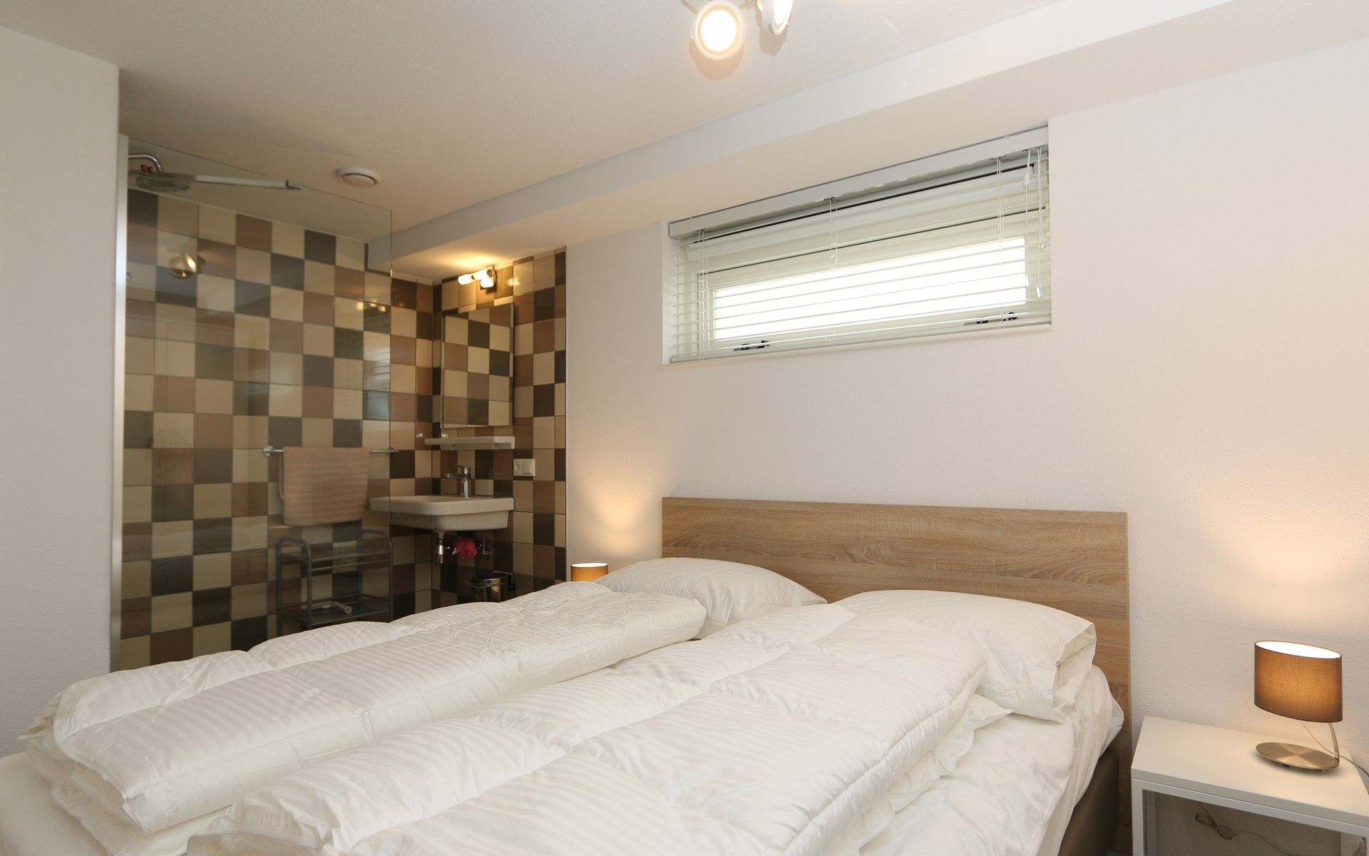 Mon Repos bedroom in Renesse with beach art and luxury bathroom