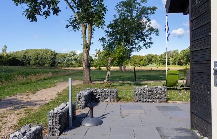 Spacious terrace at Huisje in Renesse, a vacation home in Schouwen-Duiveland, ideal for relaxation.