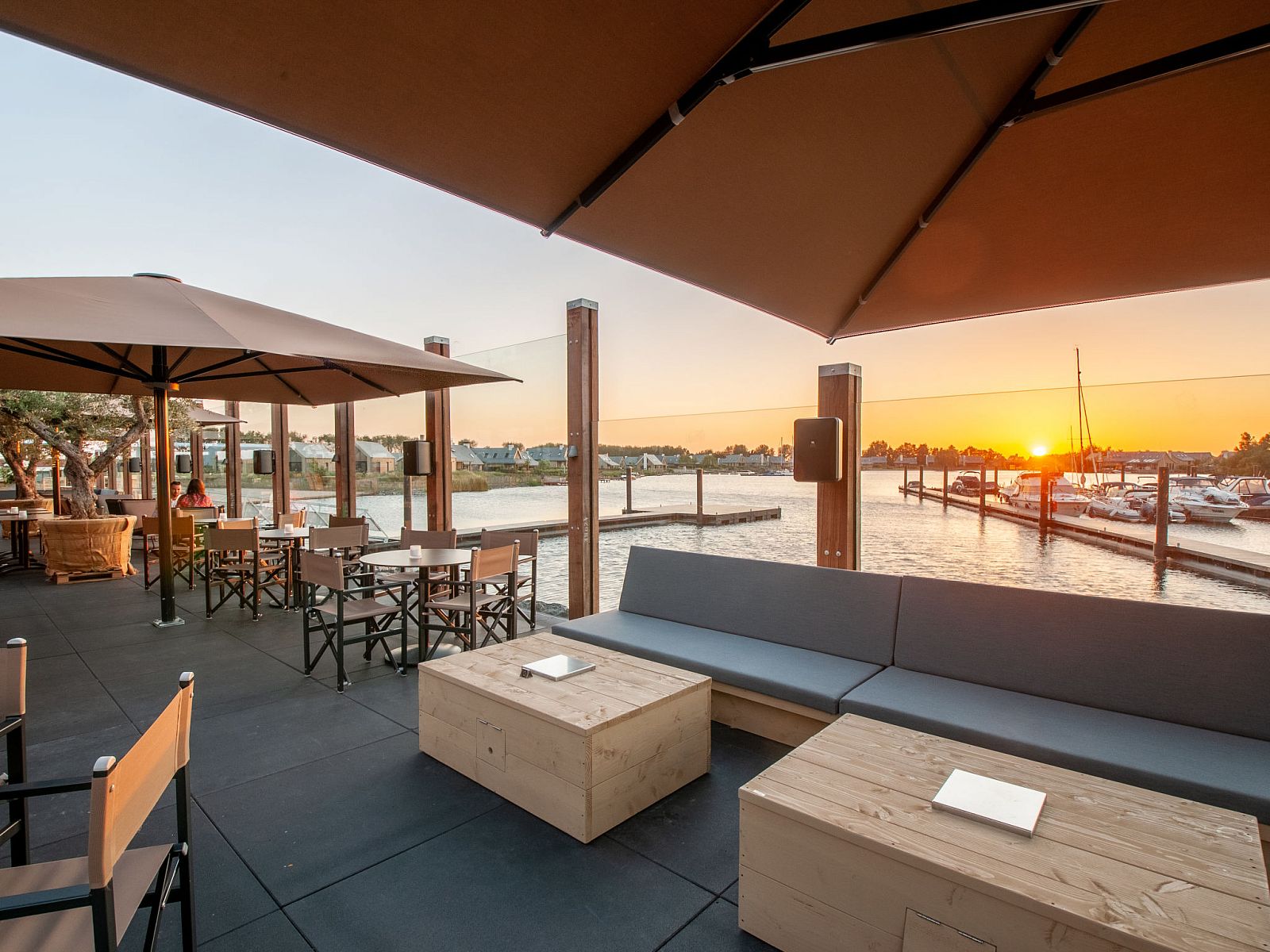 Terrace overlooking the harbor in Oesterdam Resort, Tholen, perfect for sunsets.