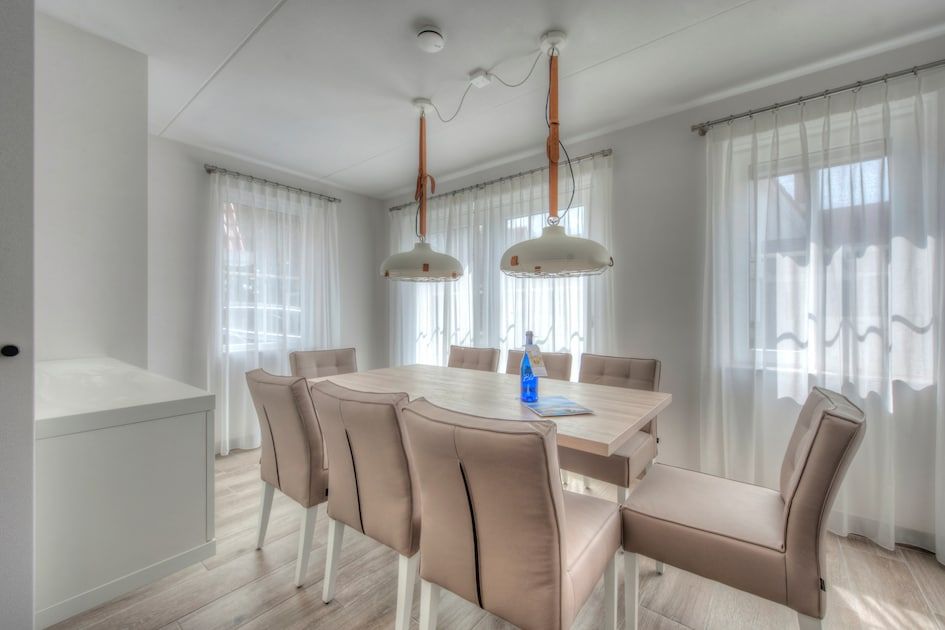 Stilvolles Esszimmer des Ferienhauses De With Luxe 8 in Koudekerke, Walcheren, Zeeland mit moderner Einrichtung und viel natuerlichem Licht.