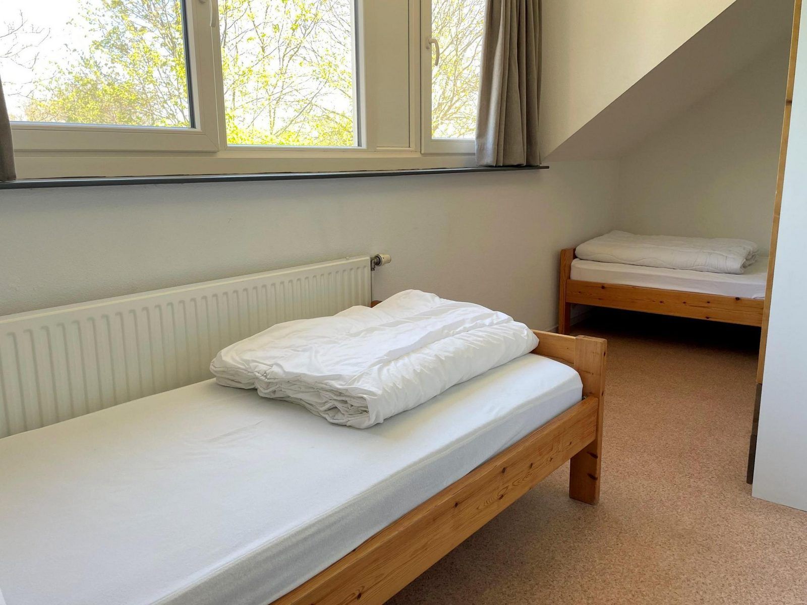 Bright bedroom with view in VZ034 Apartment Koudekerke, vacation home in Koudekerke, Walcheren, with comfortable beds.