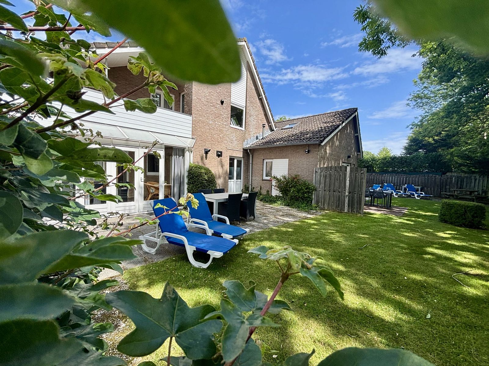 Spacious garden at Apartment Boszicht 1 in Oostkapelle, Walcheren, with deck chairs and green views.