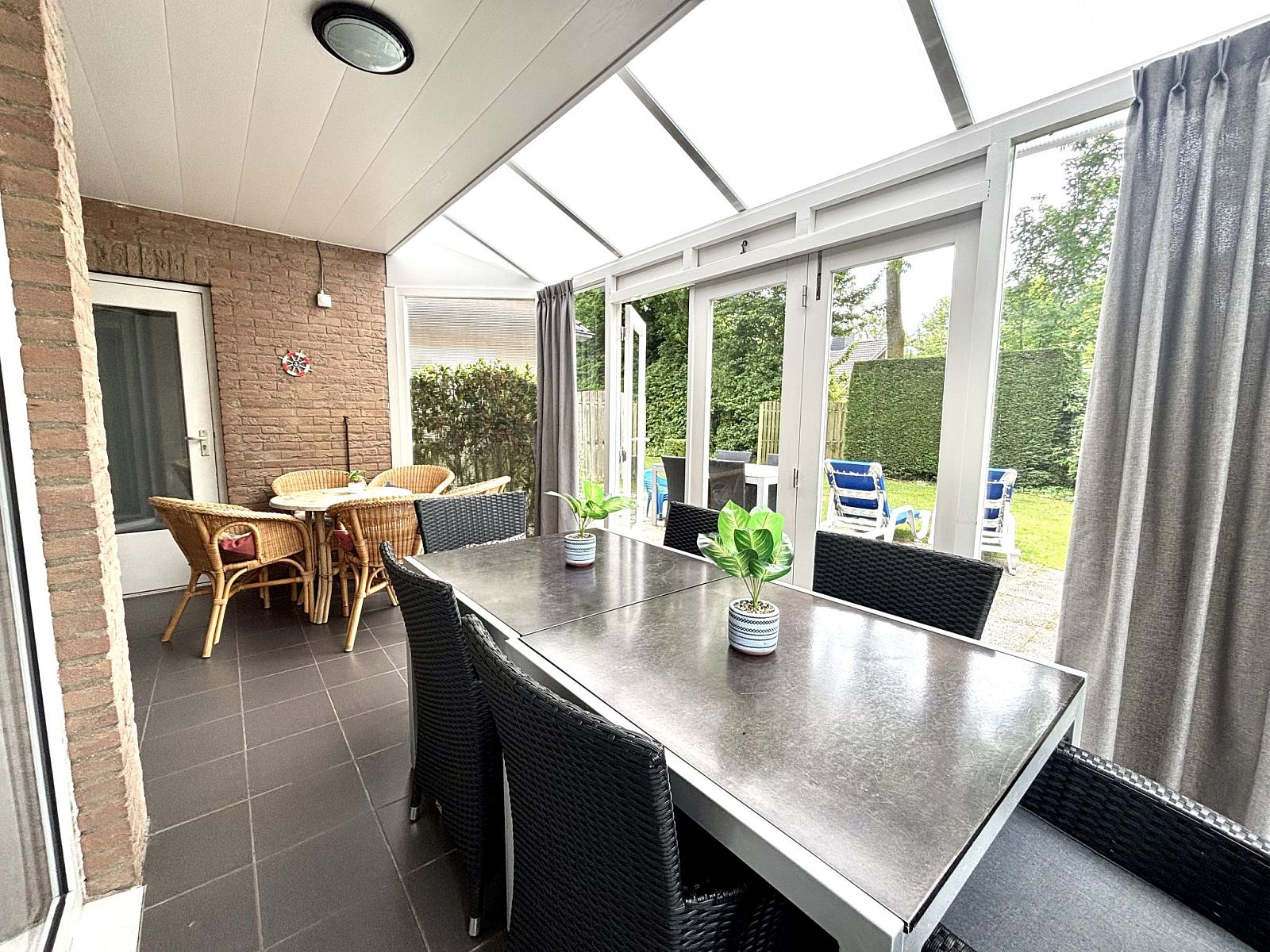 Veranda with garden furniture in Apartment Boszicht 1, Oostkapelle, Walcheren, for outdoor dining.