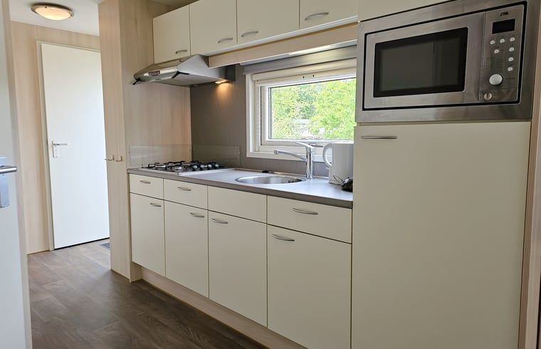 Praktische Kueche in Cottage in Oostkapelle, einem Ferienhaus in Walcheren, Zeeland, mit viel Stauraum und moderner Ausstattung.