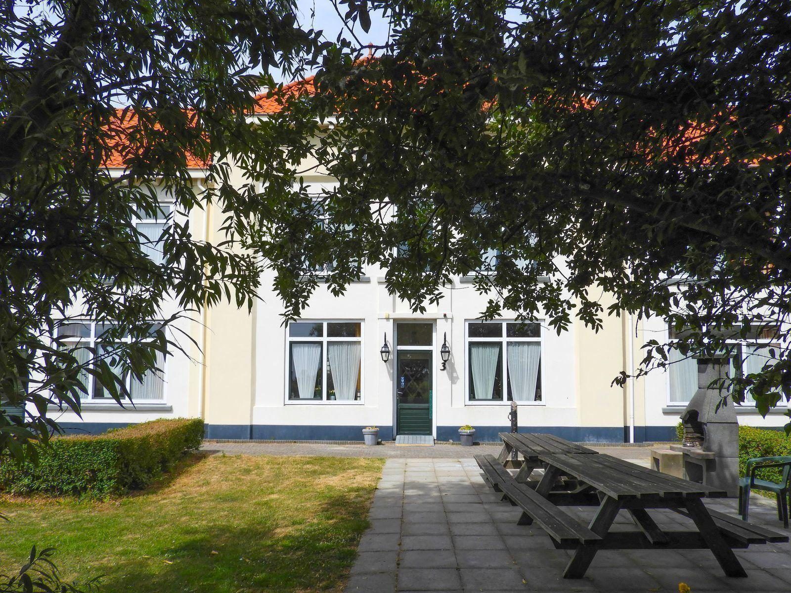 Terrace with picnic tables at VZ131 Group accommodation Westkapelle, vacation home in Zeeland.