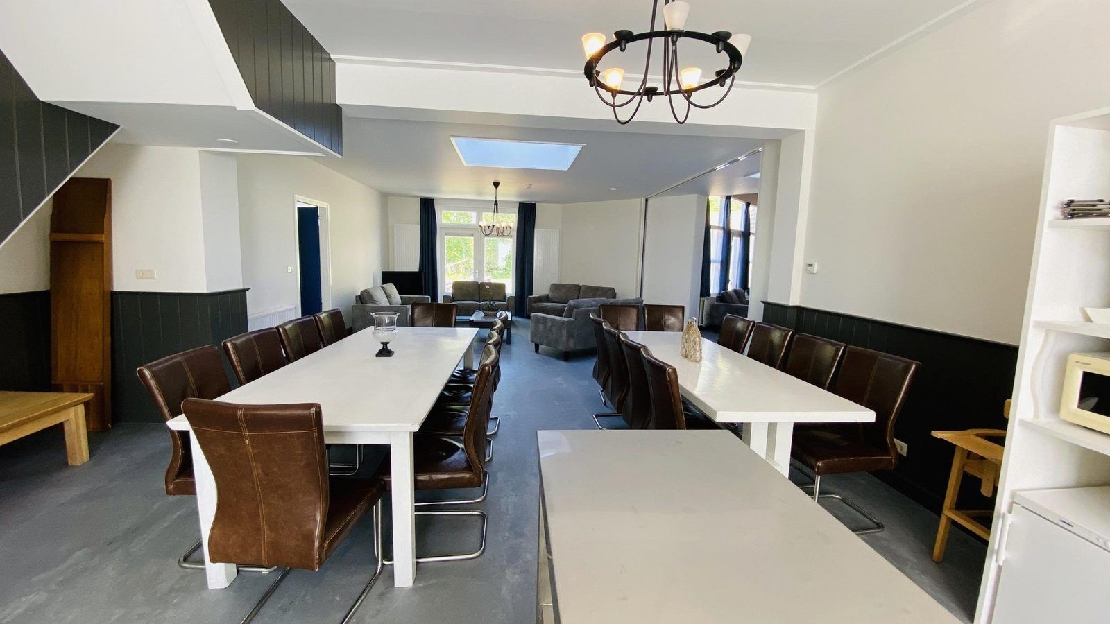 Dining area with long tables in VZ131 Group accommodation Westkapelle, vacation home in Zeeland.