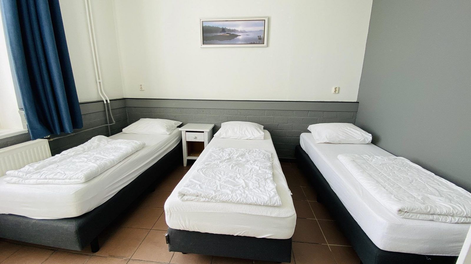 Bedroom with three beds in VZ131 Group accommodation Westkapelle, vacation home in Zeeland.