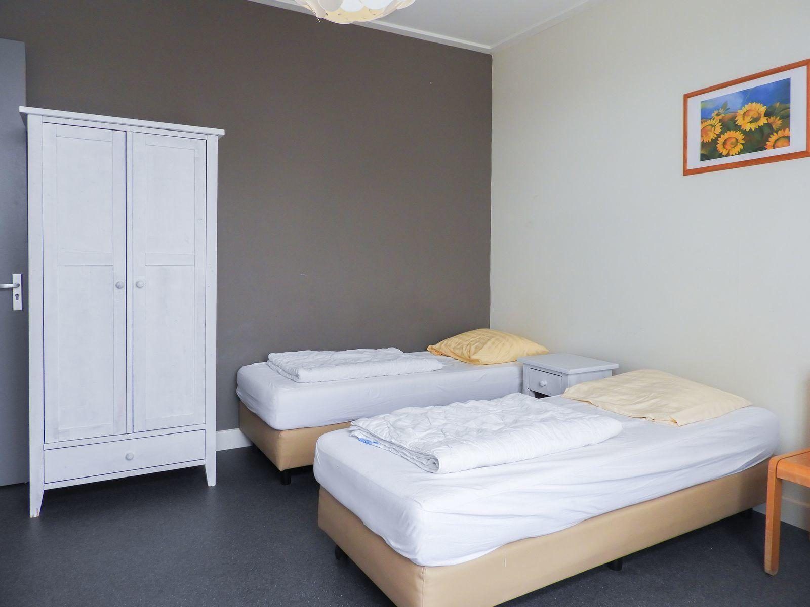 Spacious bedroom with closets in VZ131 Group accommodation Westkapelle, vacation home in Zeeland.