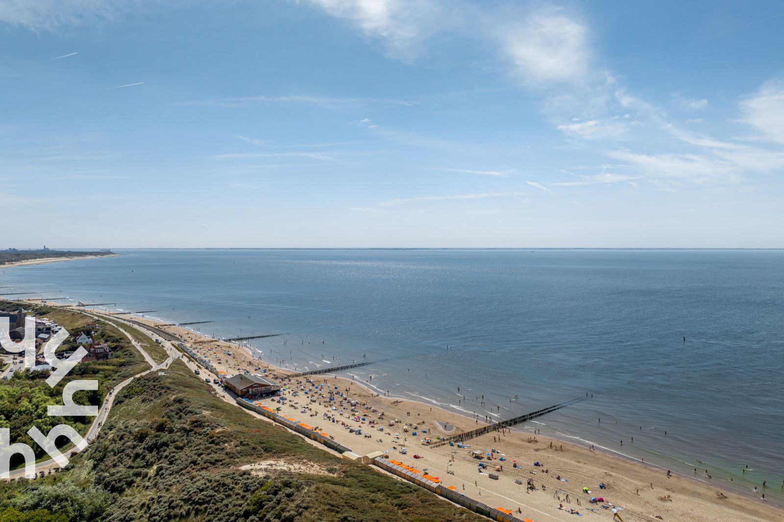 Open keuken in vakantiehuis ZE312 in Zoutelande, Walcheren met houten kasten en moderne apparatuur in Zeeland.