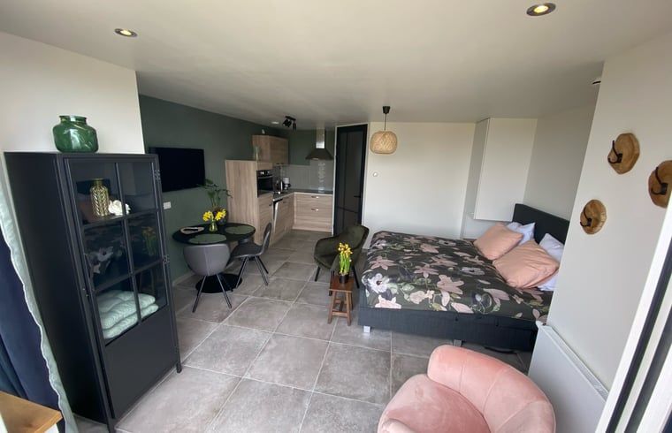 Exterior of Holiday home in Vrouwenpolder, Walcheren, Zeeland surrounded by colorful flowers.