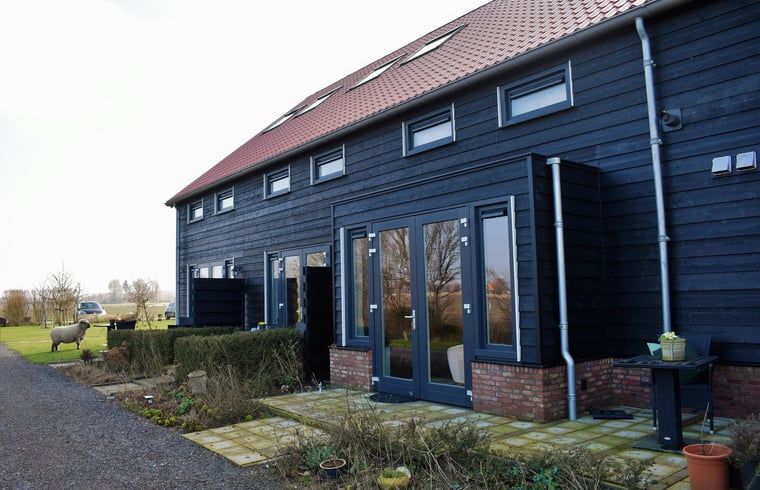Terrace at Holiday Home in Vrouwenpolder, Walcheren, Zeeland with seating and views.