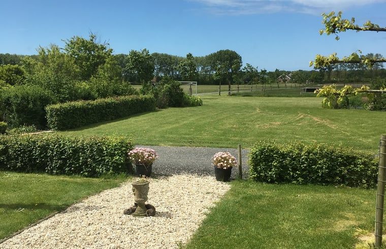 Spacious garden at Holiday home in Vrouwenpolder, Walcheren, Zeeland with beautiful green landscape.