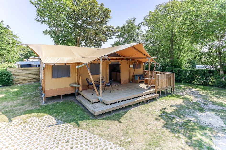 Innenbereich von Safari-Zelt 8 in Vrouwenpolder, Walcheren, Zeeland mit Kueche und einladender Terrasse fuer Glamping-Erlebnisse.