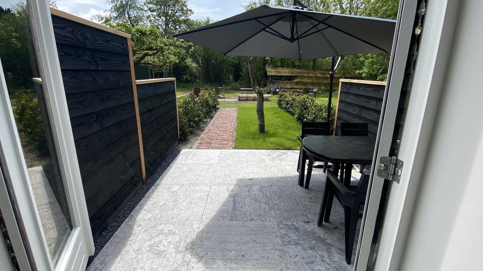 Cozy terrace of VZ1022 Holiday apartment in Veere, Walcheren, Zeeland overlooking the garden.