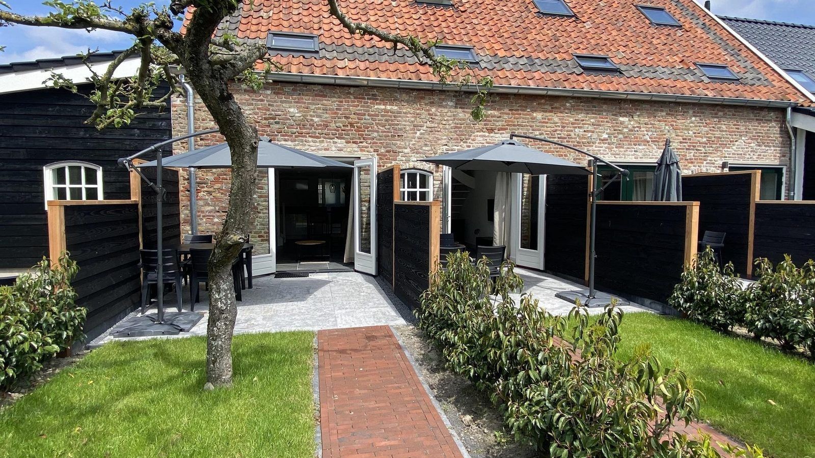 Rustic exterior of VZ1022 Holiday apartment in Veere, Walcheren, Zeeland with sunny terrace.