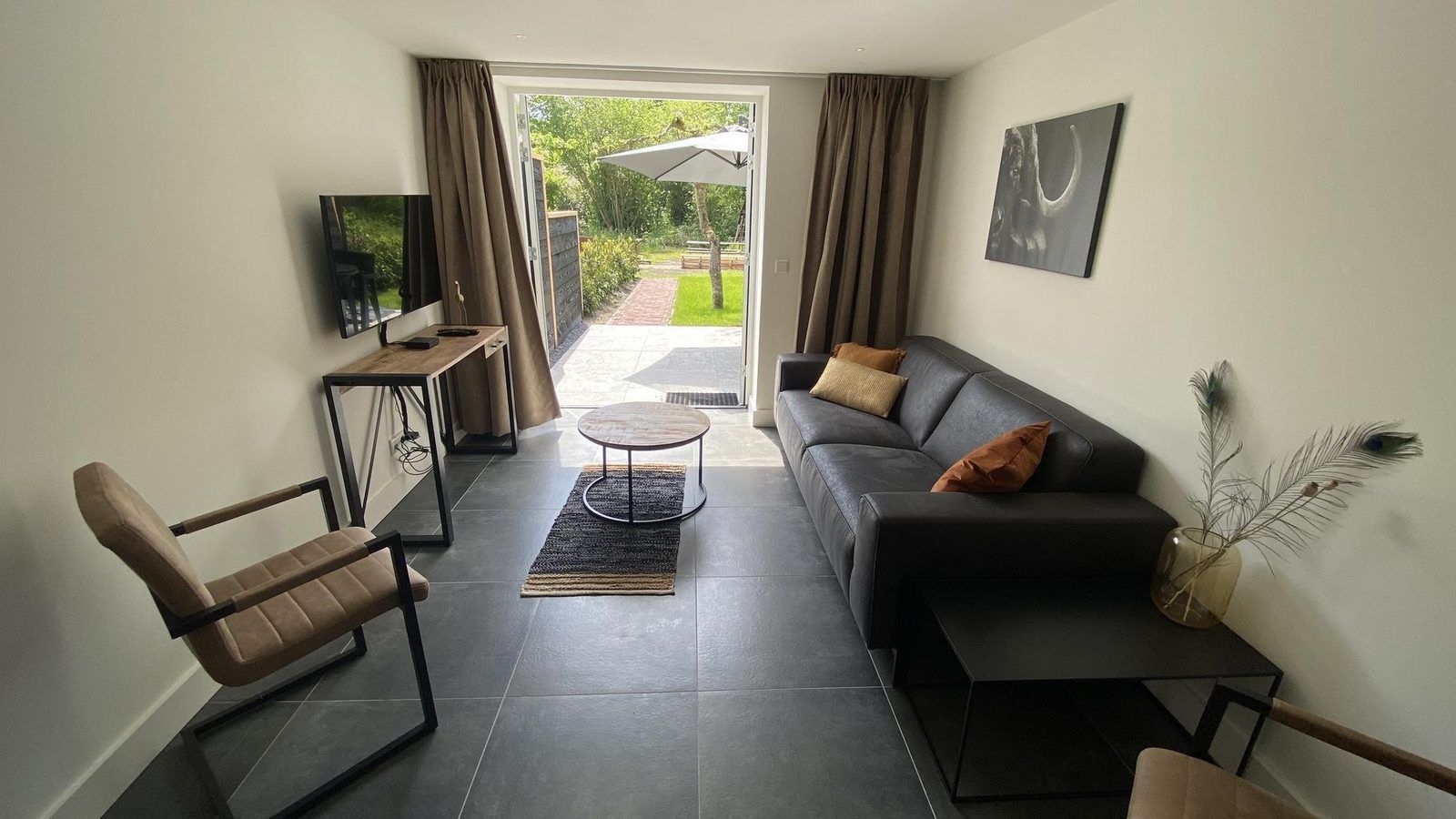 Bright living room of VZ1022 Holiday apartment in Veere, Walcheren, Zeeland with access to terrace.
