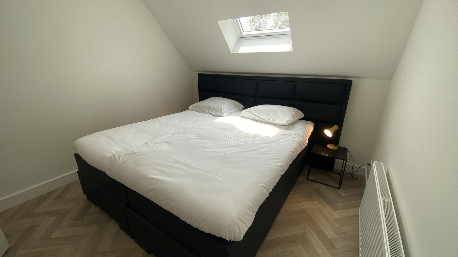 Cozy bedroom of VZ1022 Holiday apartment in Veere, Walcheren, Zeeland with skylight.