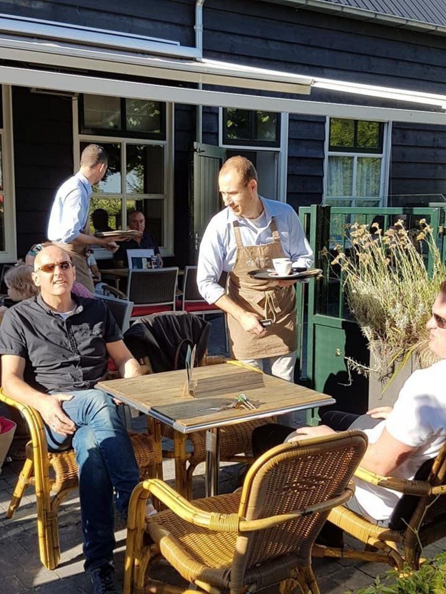 Friendly staff serves on the terrace of VZ824 Chalet in Veere, Serooskerke, Walcheren.